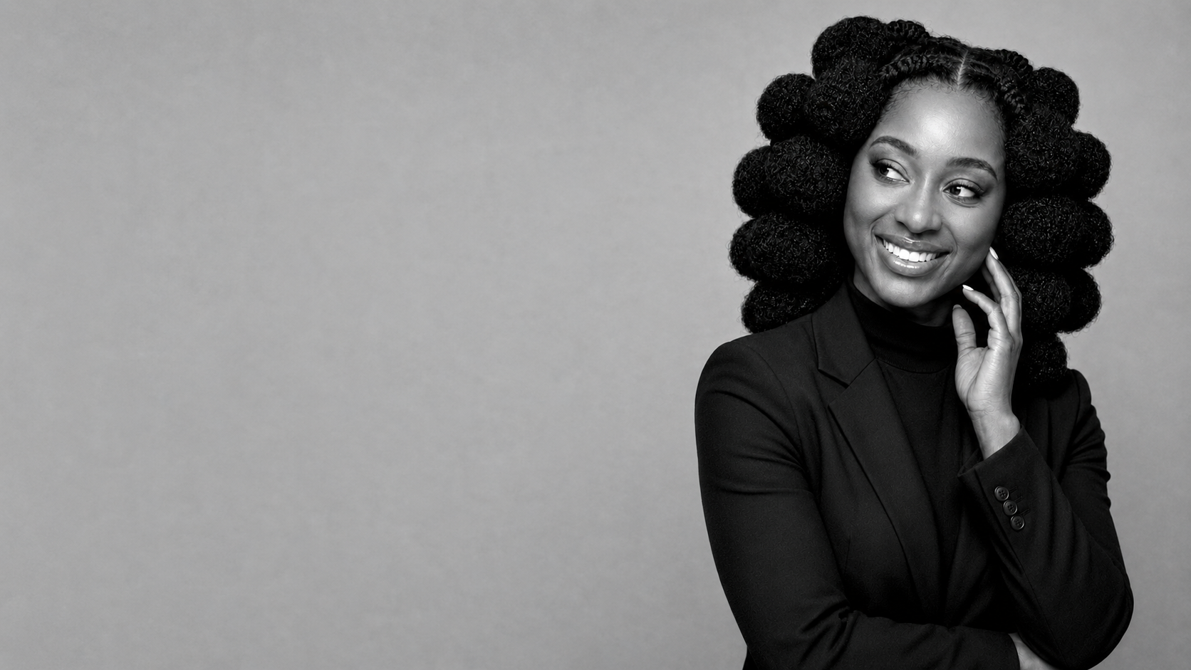 Shiloh smiling in a dramatic black-and-white portrait