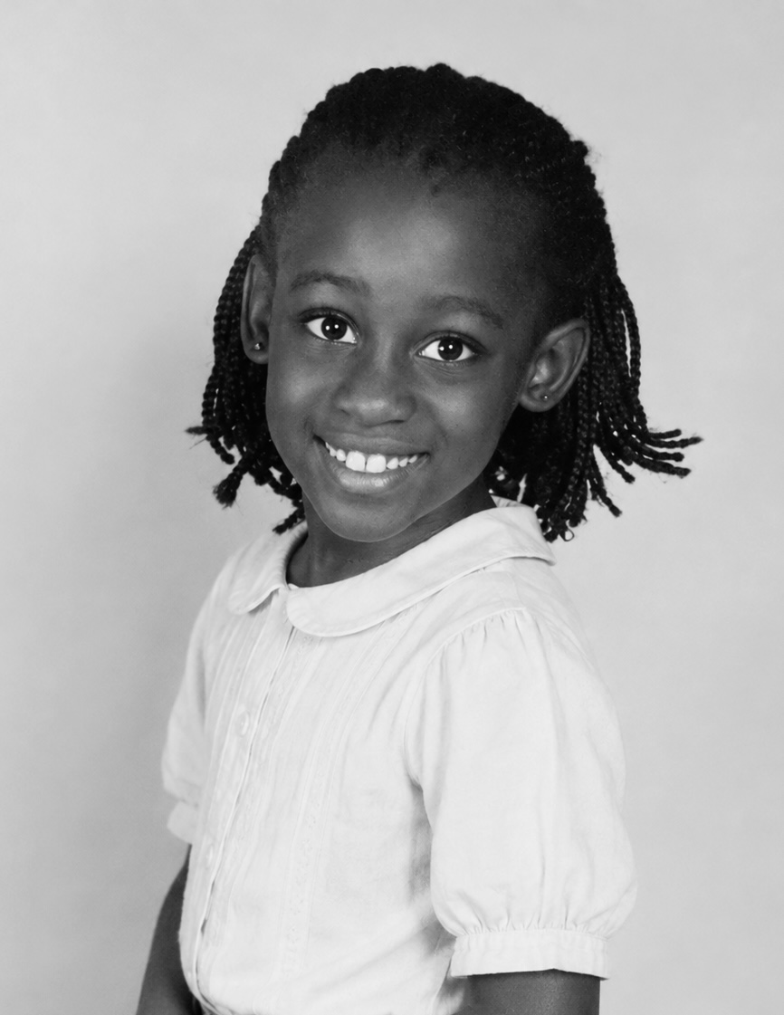 Black-and-white childhood portrait of Shiloh smiling