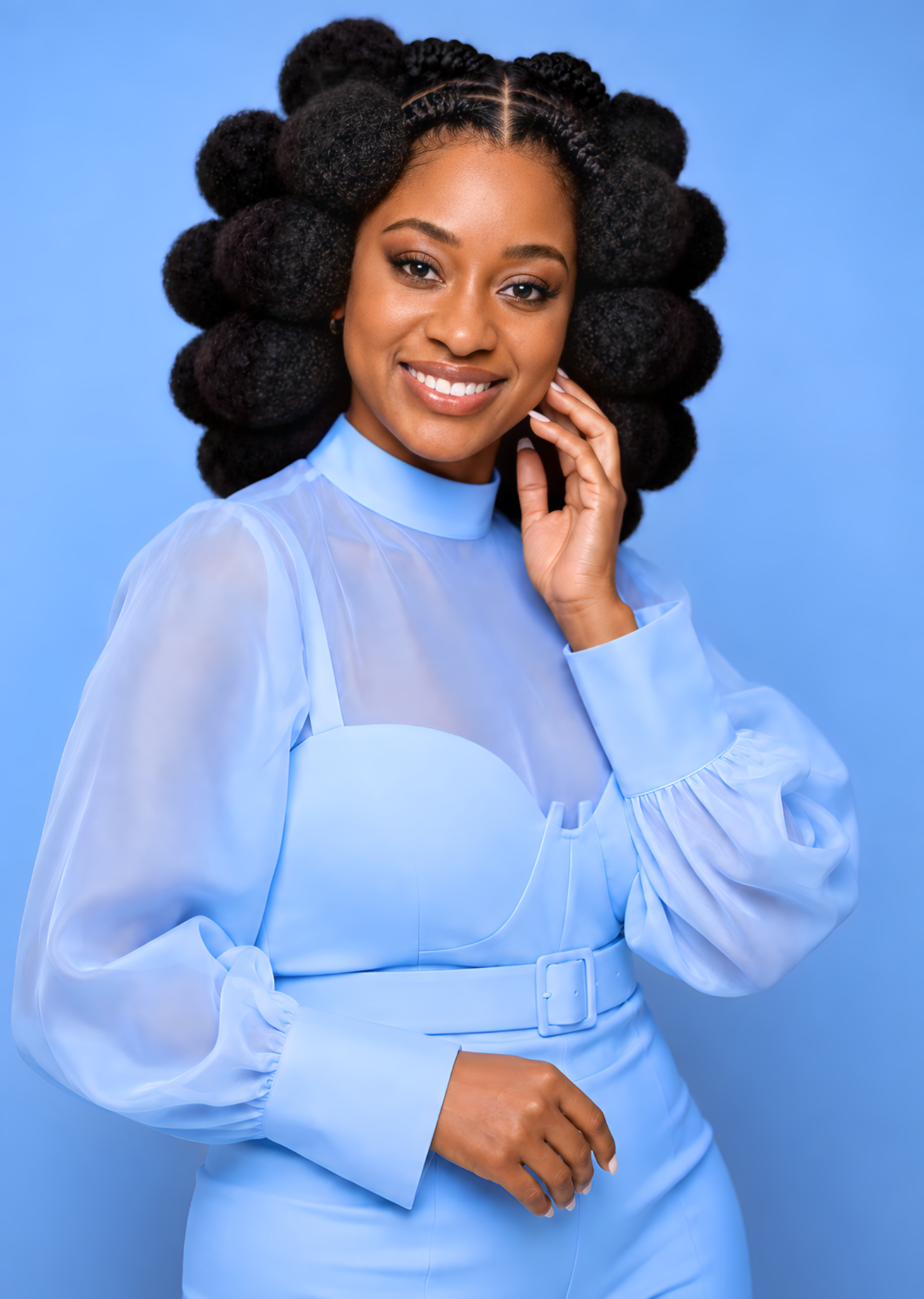 Shiloh smiling in a soft blue outfit
