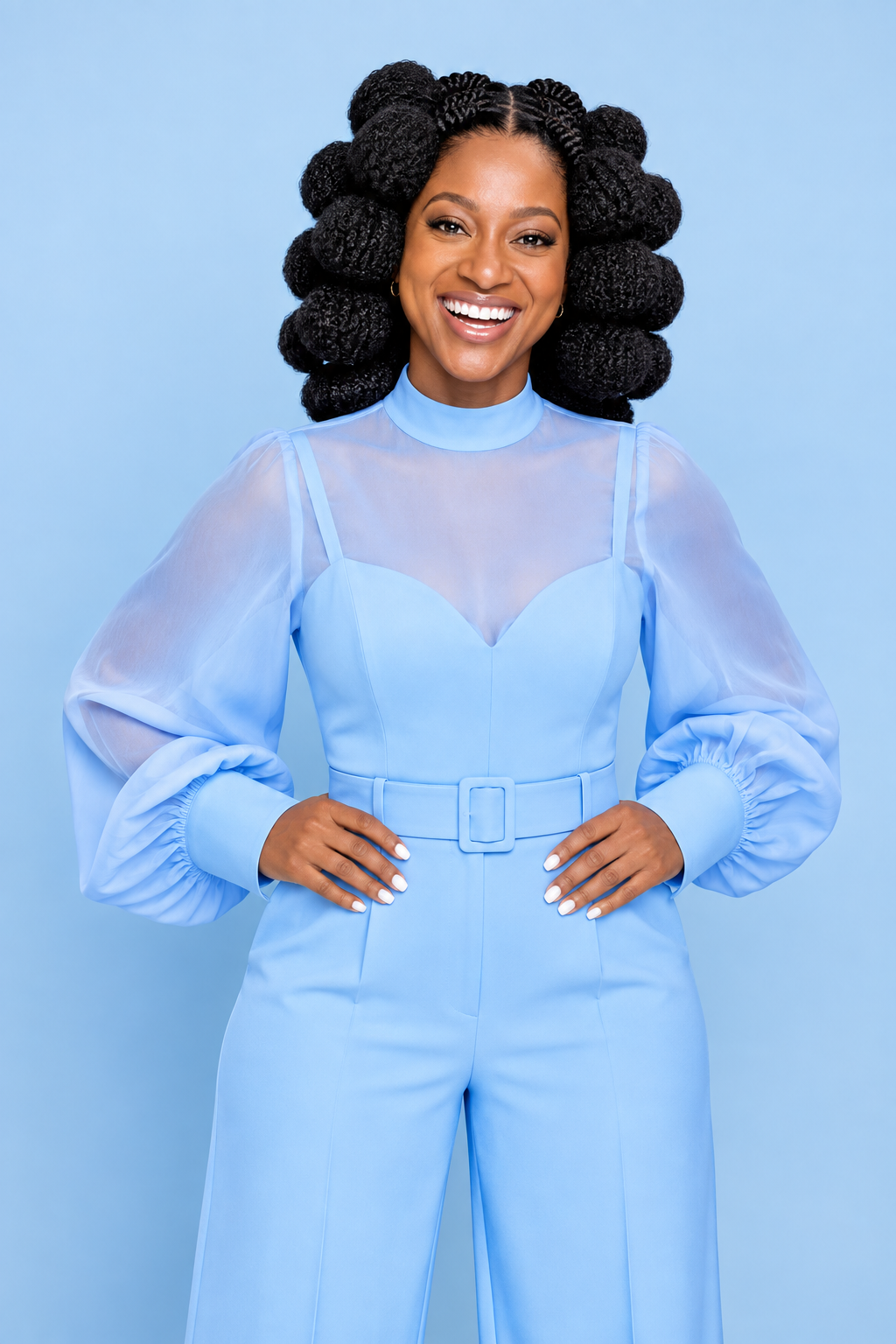 Shiloh smiling in a light blue outfit