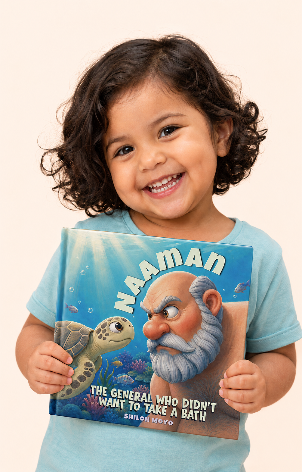 A smiling young girl holding Naaman