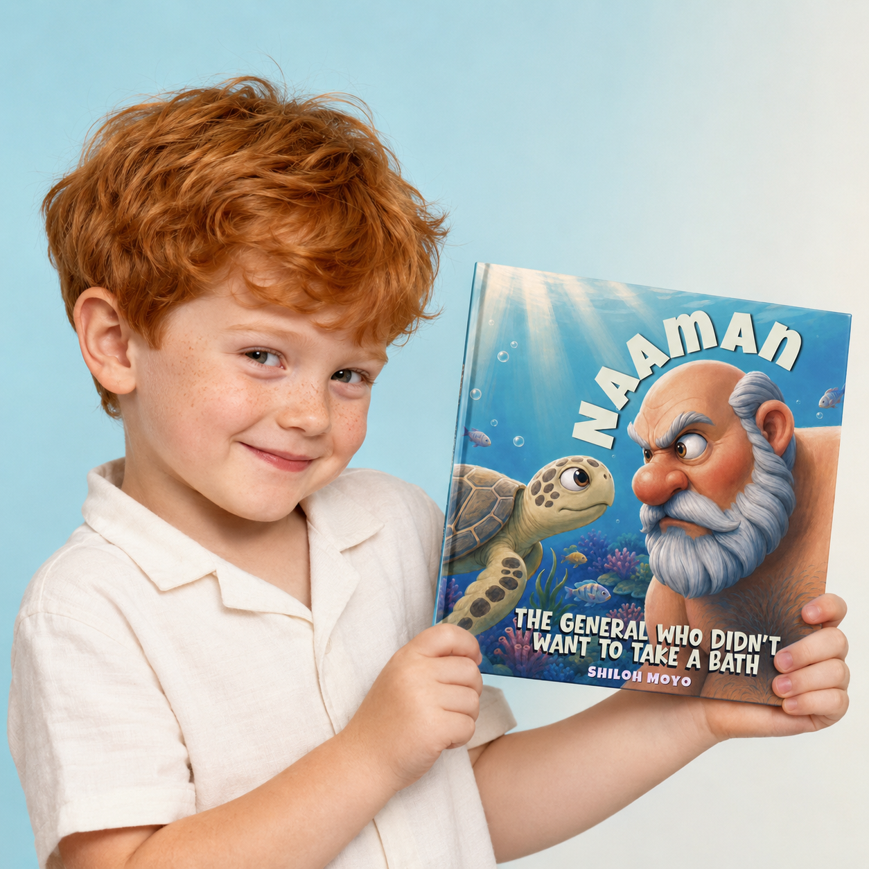 A smiling young reader holding the Naaman book